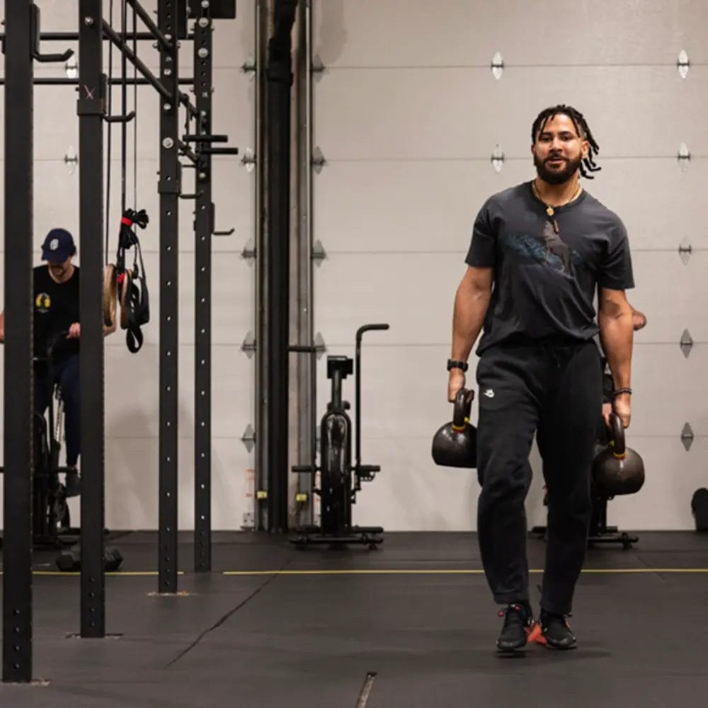 Man holding kettlebells at Mass Strength and Conditioning